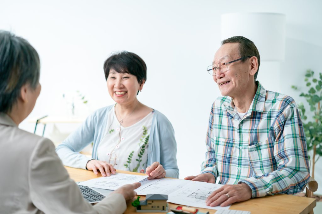 不動産の相談をするシニア夫婦と営業担当者