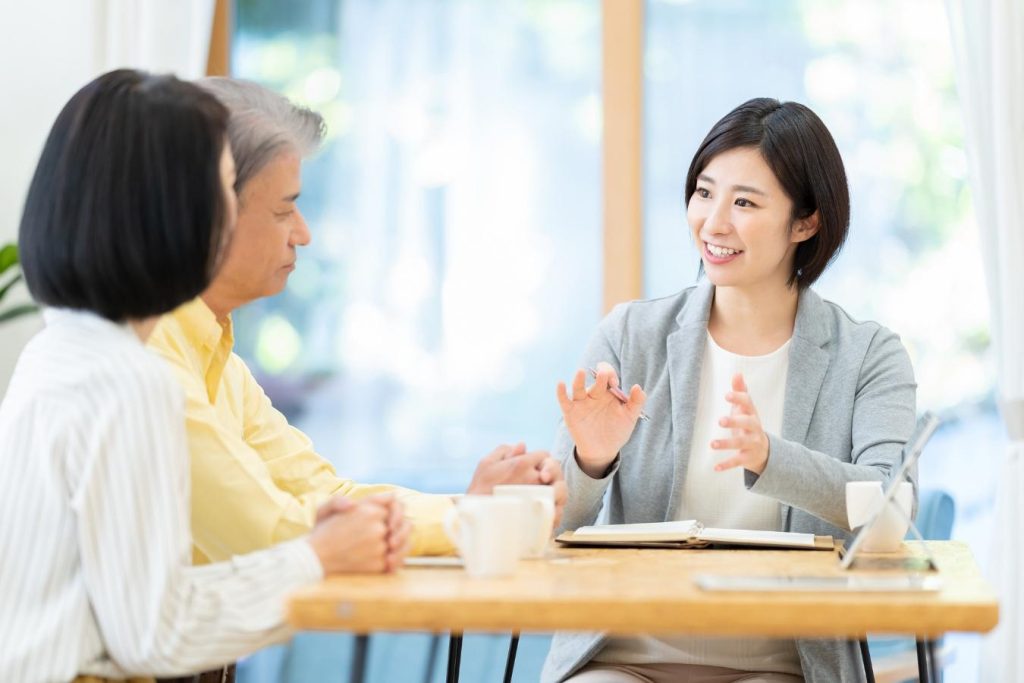女性営業担当者に相談するシニア夫婦